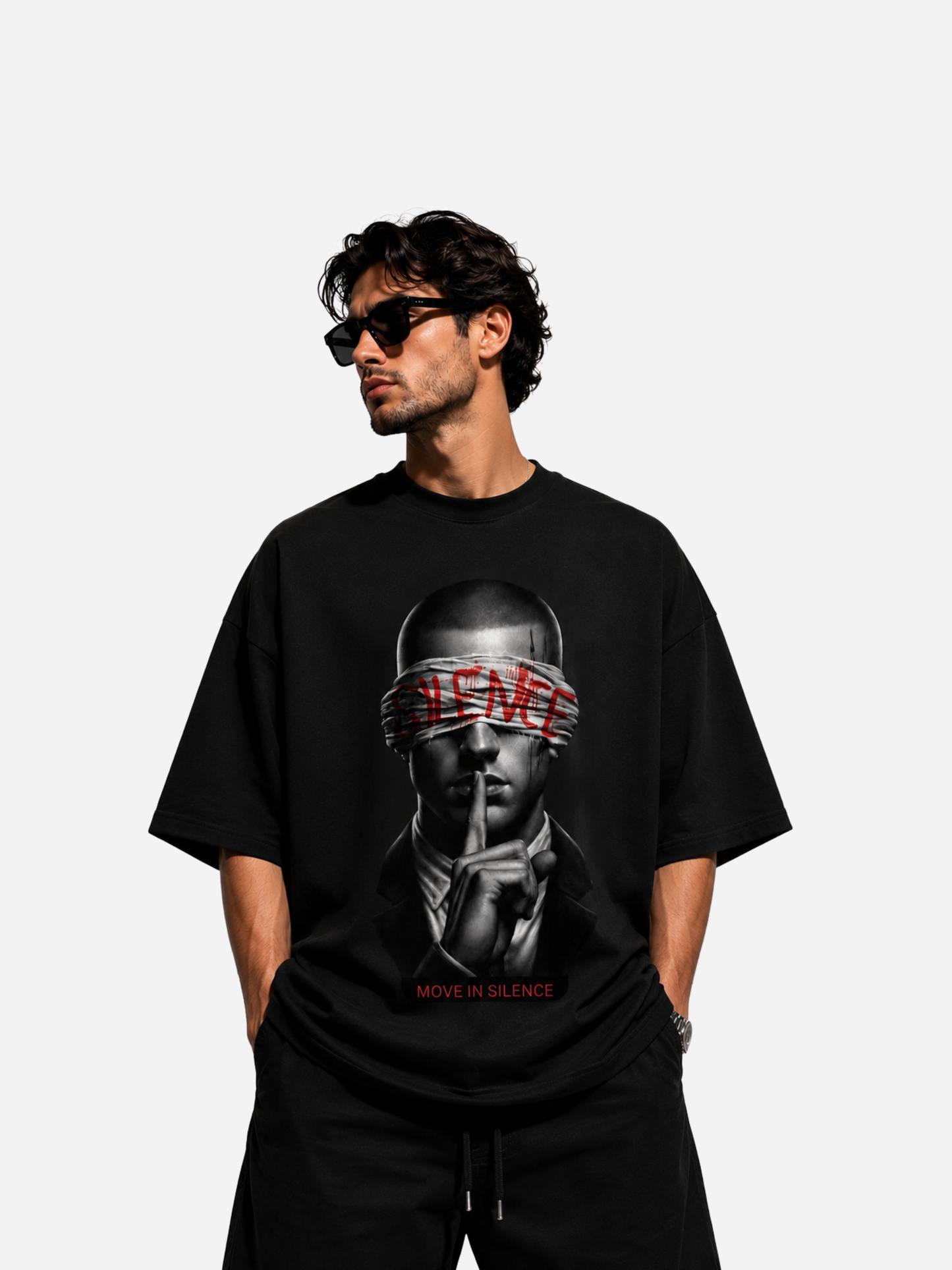 Mann im schwarzen Oversized T-Shirt mit MOVE IN SILENCE Motiv, schwarz-weißem Porträt und roter Schrift. Modernes Streetwear Shirt für Herren mit hochwertigem Druck und urbanem Fashion Look.