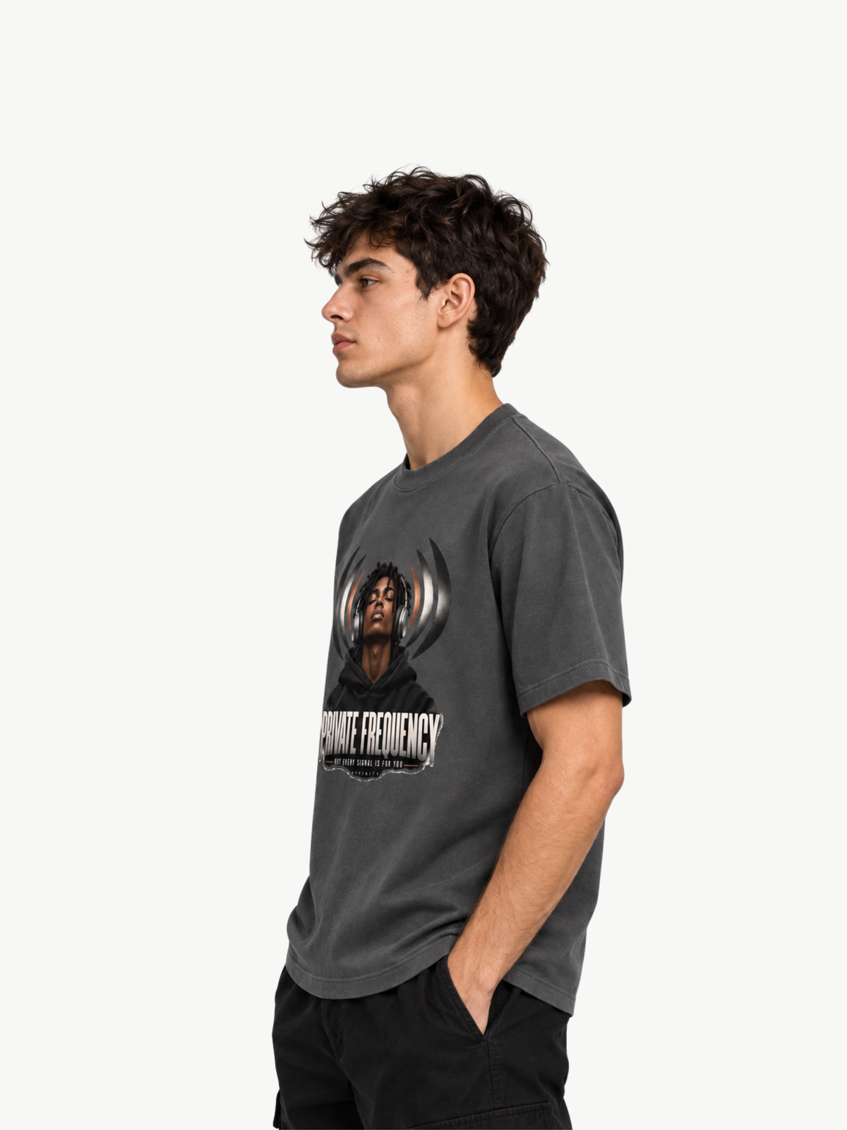 Männliches Model in Seitenansicht mit dunkelgrauem VYFINITY Regular Fit T-Shirt und „PRIVATE FREQUENCY“-Frontprint, 180 GSM.
