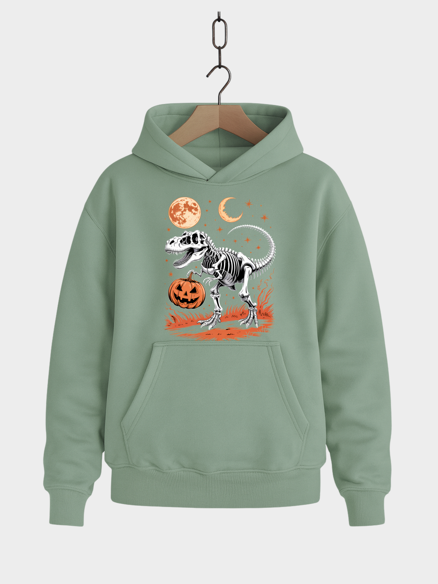 Grüner Halloween Hoodie auf Kleiderbügel mit T-Rex-Skelett Design, orangem Kürbis, Vollmond, Halbmond und Sternen.