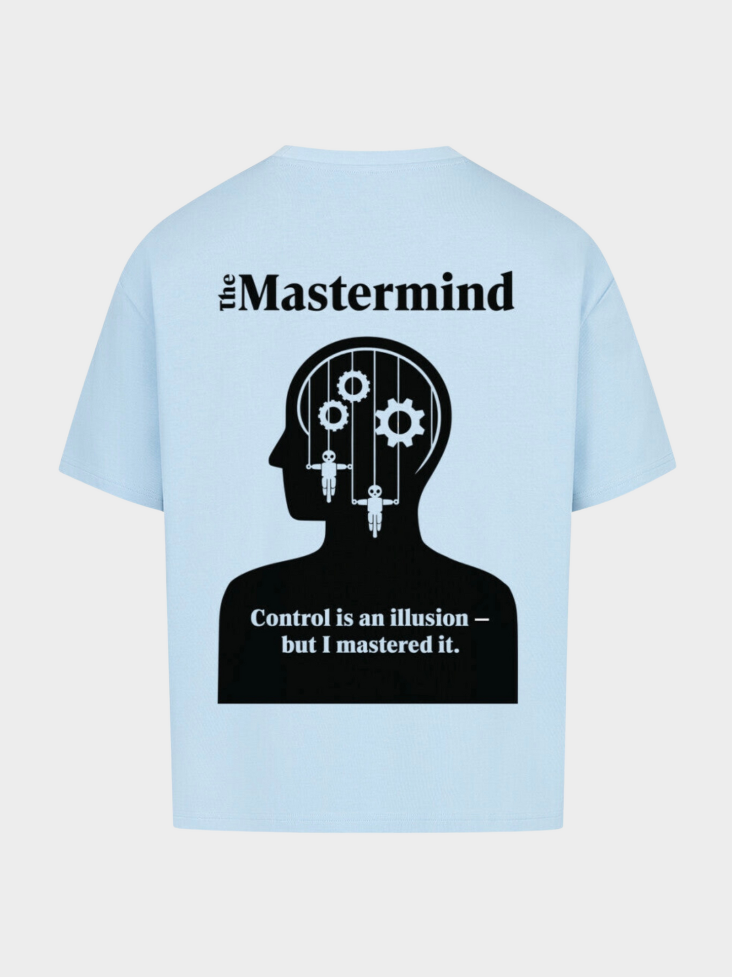 Oversized T-Shirt in Hellblau, Rückseite. Großes Mastermind-Design mit schwarzer Kopf-Silhouette, Zahnrädern und Puppenmarionetten im Inneren. Darüber der Schriftzug „The Mastermind“. Darunter der Spruch: „Control is an illusion – but I mastered it.“ Moderner Streetwear-Style mit markantem Print.