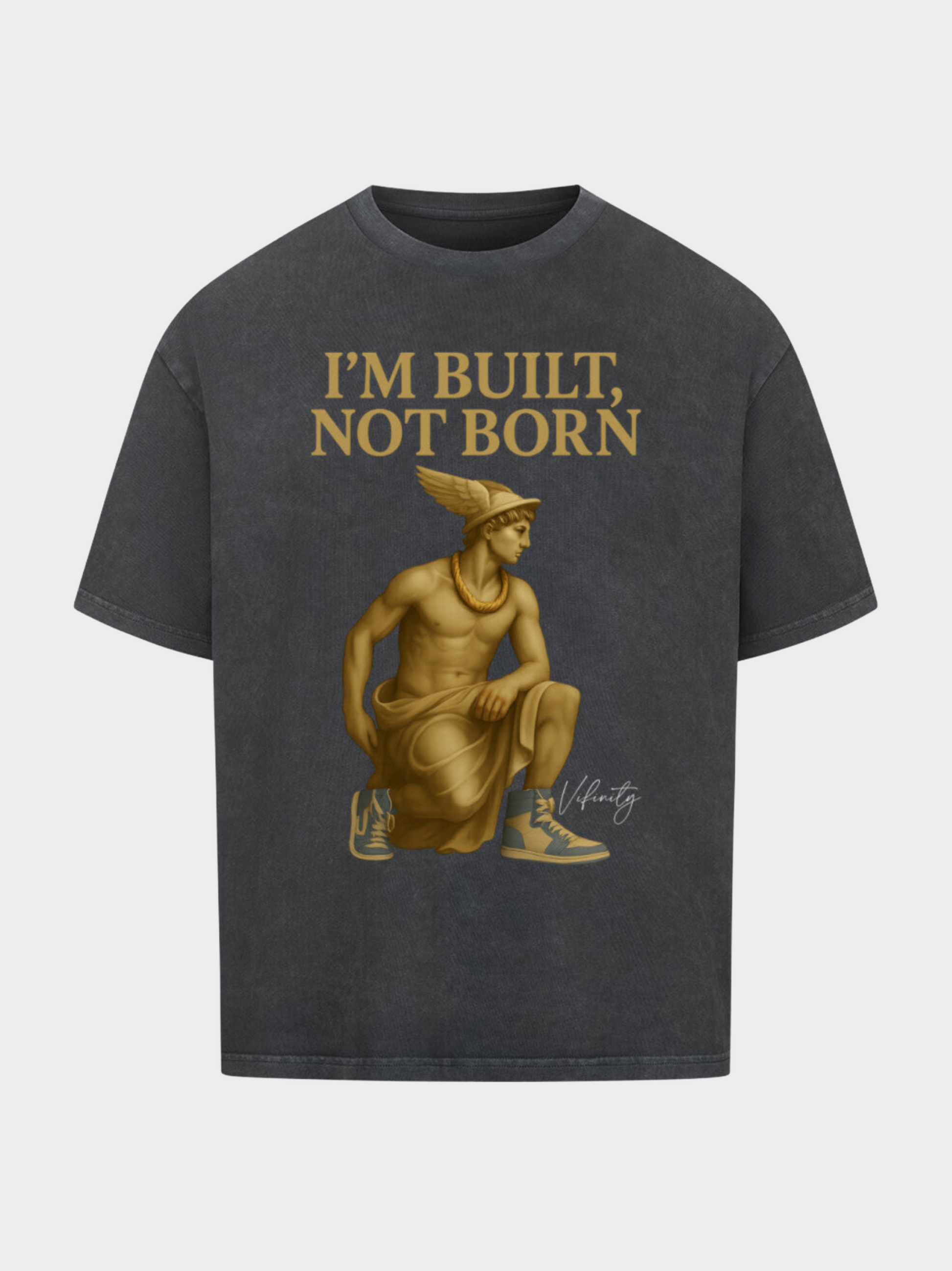Oversize T-Shirt in Washed Black / Vintage Schwarz mit goldener Statue im antiken Stil, kombiniert mit modernen Sneakers. Goldener Schriftzug „I’M BUILT, NOT BORN“ für urbanen Streetwear-Look mit Motivations-Statement.